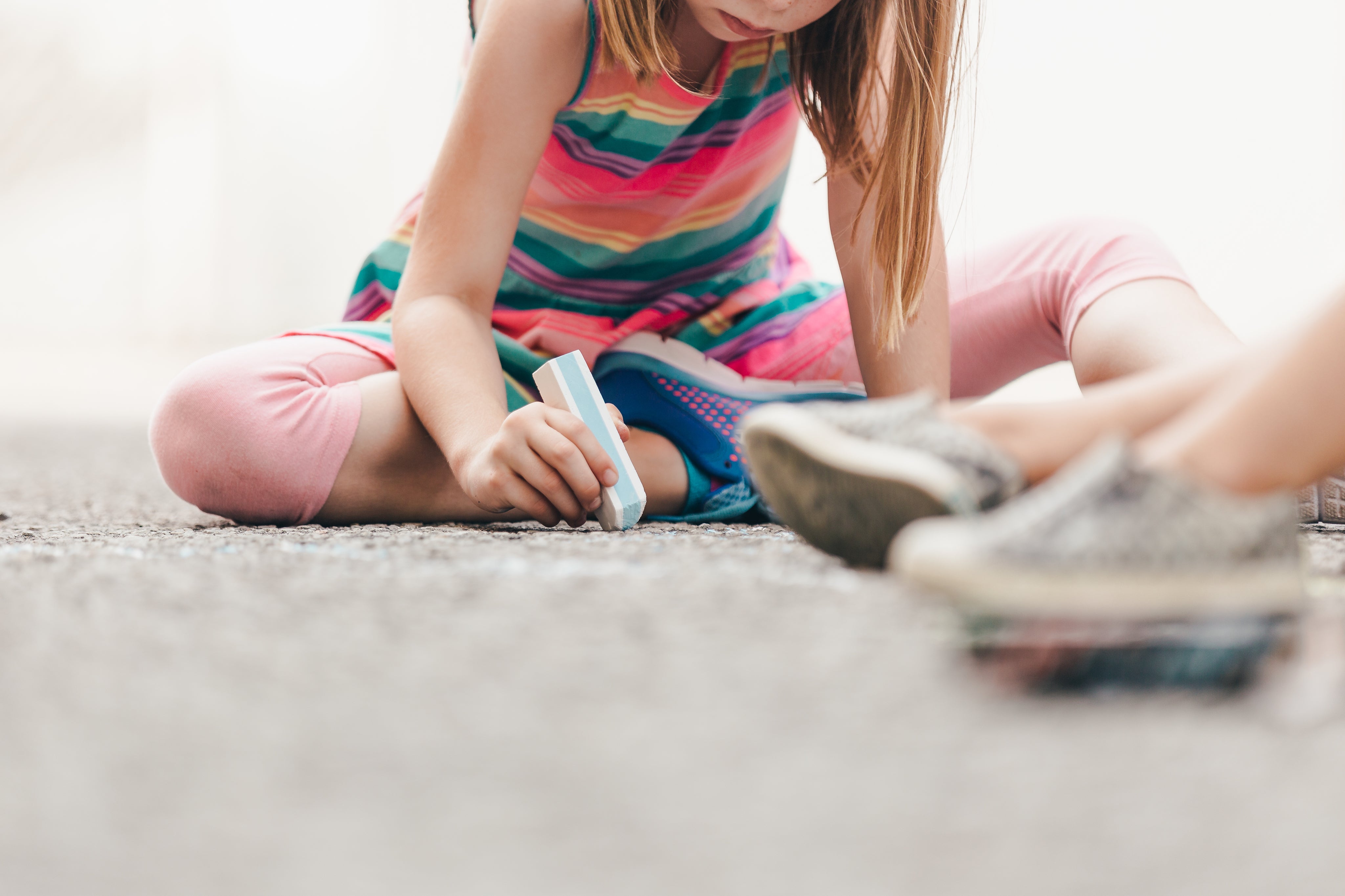 little-girl-drawing-with-chalk-on-ground.jpg
