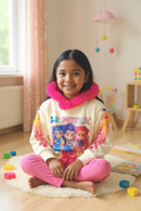 Young girl sitting on a rug in a room with colorful blocks and toys.